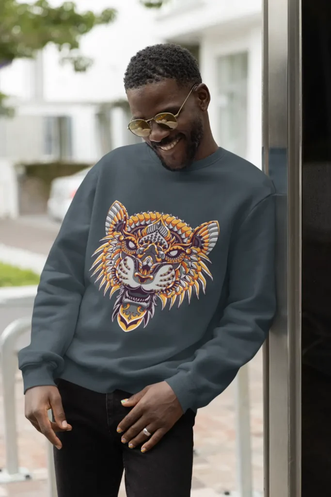 Man wearing tiger design sweatshirt, smiling outdoors.