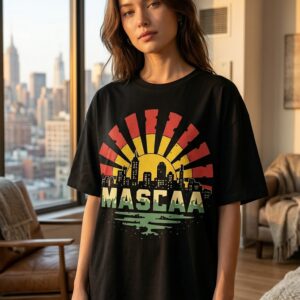 Woman wearing black graphic t-shirt indoors.